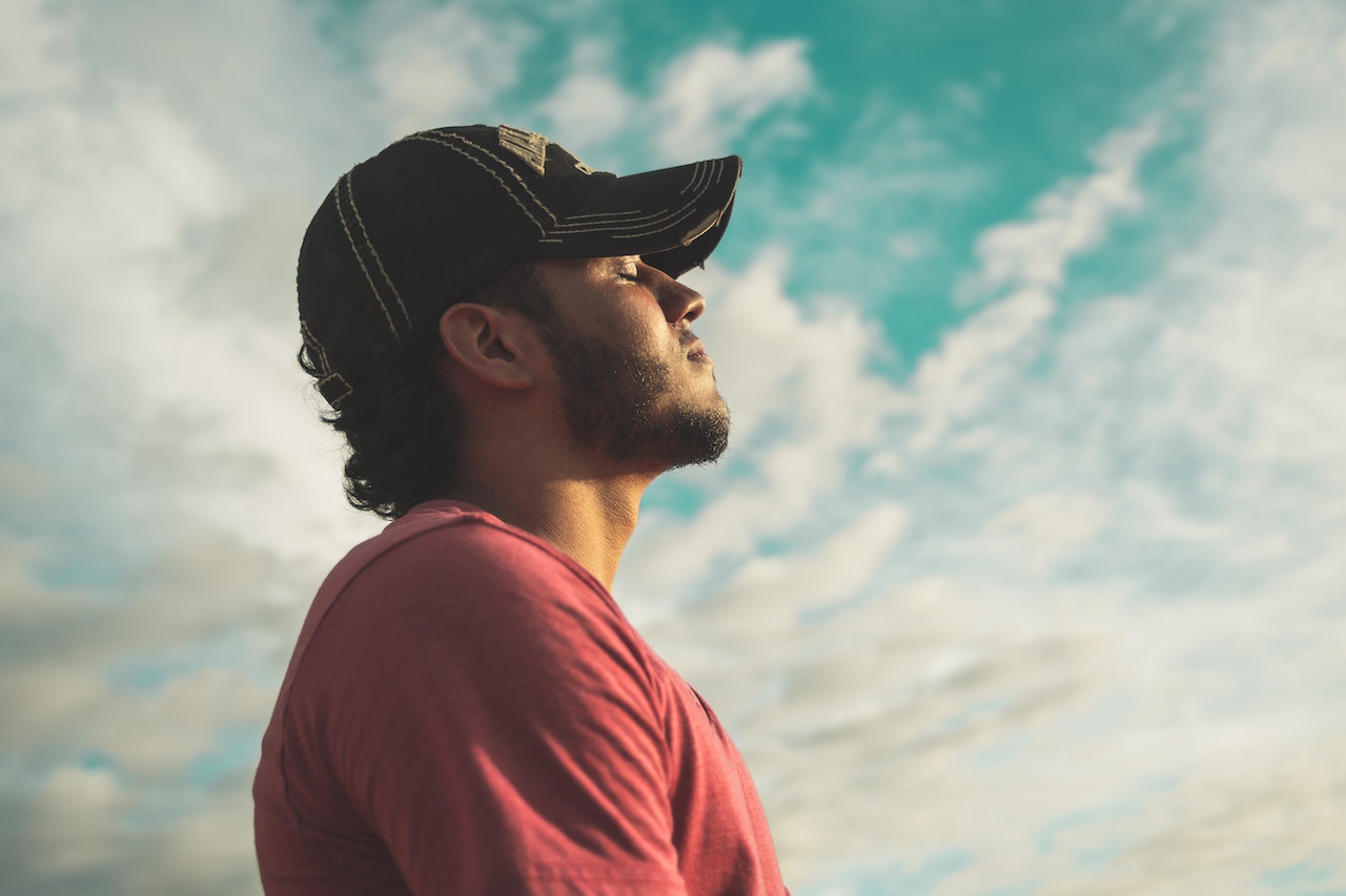 Man with closed eyes, facing the sky