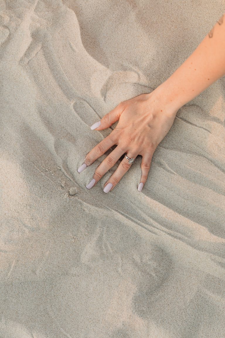 A woman's hand on sand